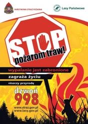 Plakat promujący akcję: Stop pożarom traw. Na plakacie ośmiokątny znak stop. W tle numer straży 998 oraz płomienie na żółtym tle.
