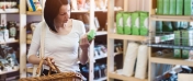 Kobieta czytająca etykietę produktu, który trzyma w rękach