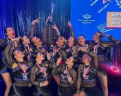 Cheerleaderki patrzą do góry i wskazują palcami