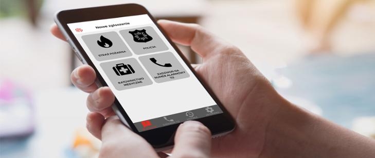 Na zdjęciu telefonj typu smartphone. Na ekranie widać kilka ikon z aplikacjami.