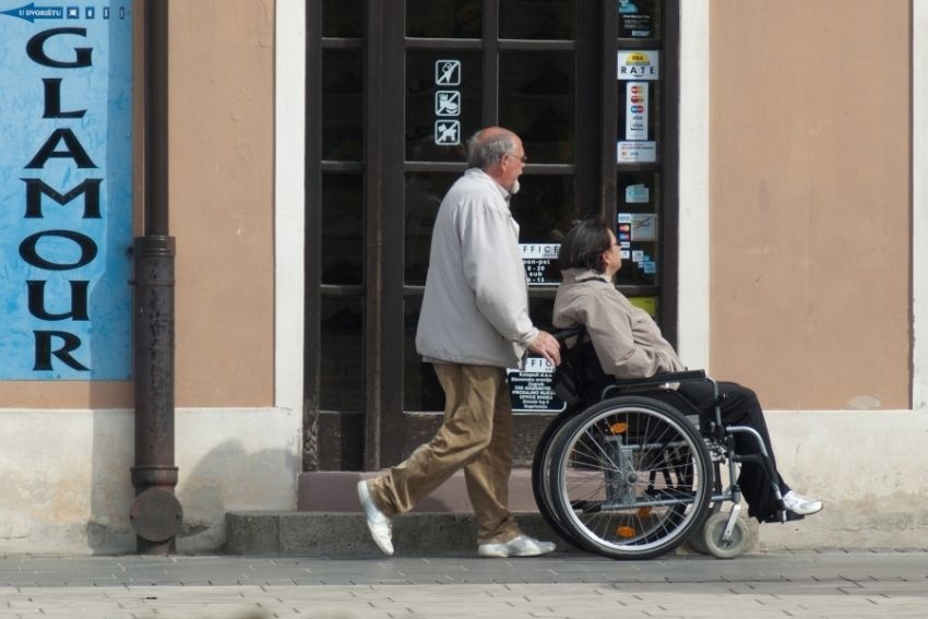 Osoba na wózku inwalidzkim wraz z opiekunem
