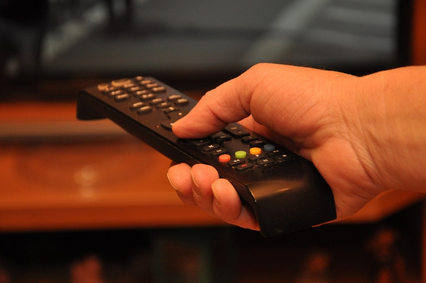 Pilot od telewizora trzymany w dłoni