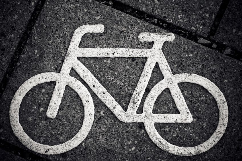 Biały znak poziomy - rower - na kostce brukowej