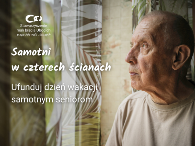 człowiek w sile wieku patrzy przez okno